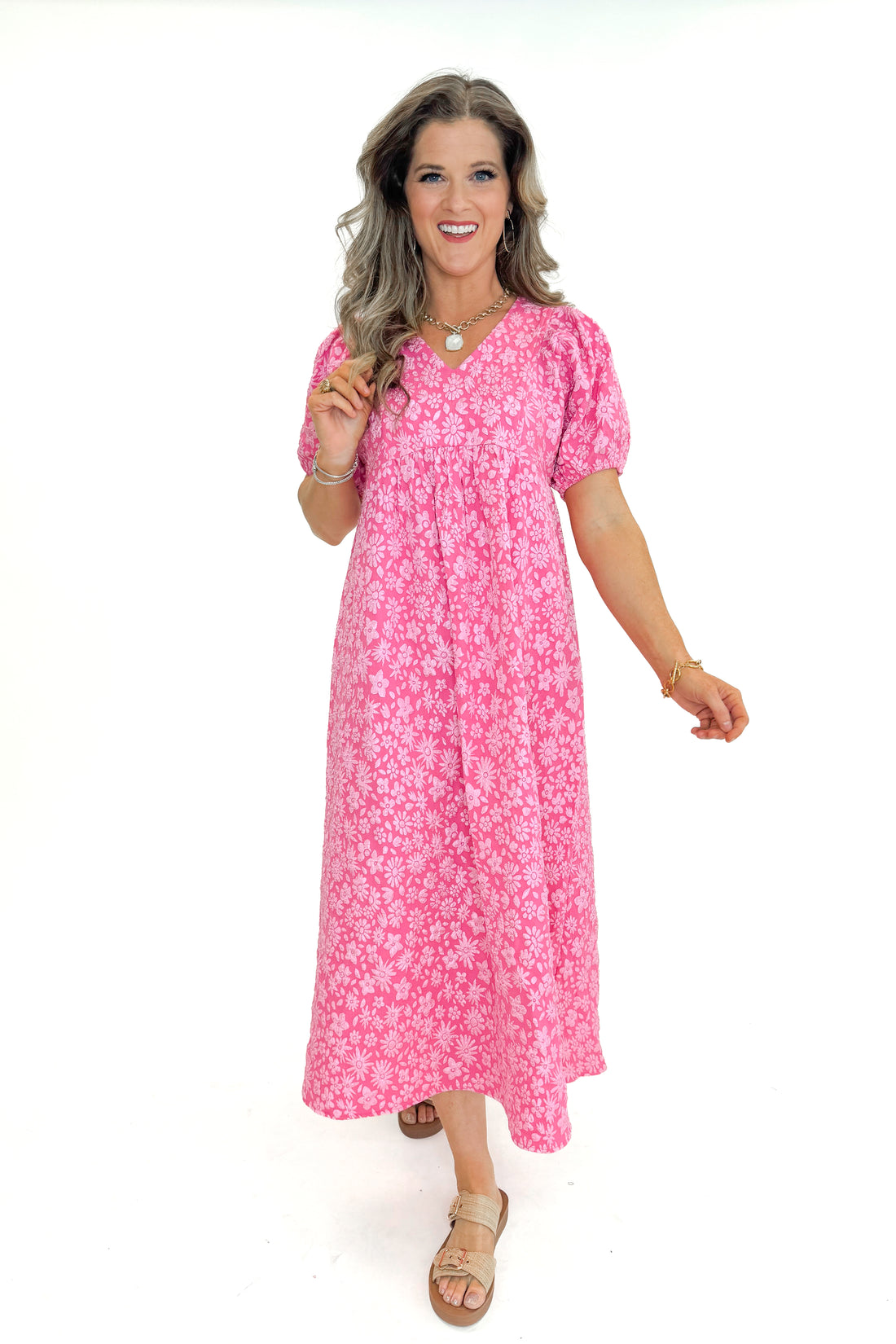 Front view of woman wearing Pink Floral Textured Puff Sleeve Midi Dress against white studio background.