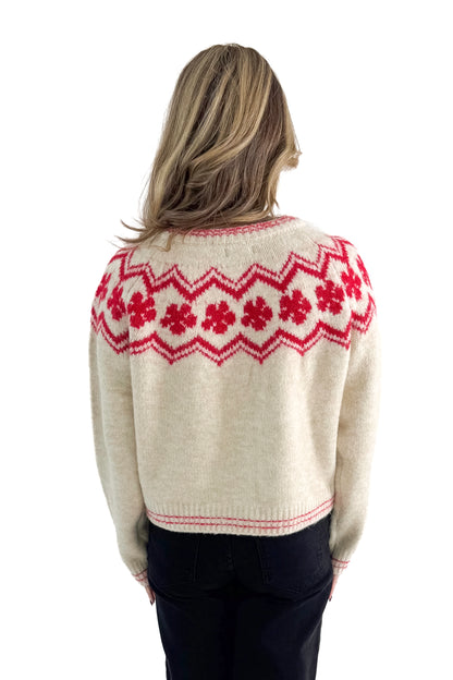 Back view of woman wearing Ivory &amp; Red Faie Isle Button Up Cardigan with jeans against white studio background.