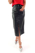 Front view of woman wearing black faux leather skirt with red top against white studio background.