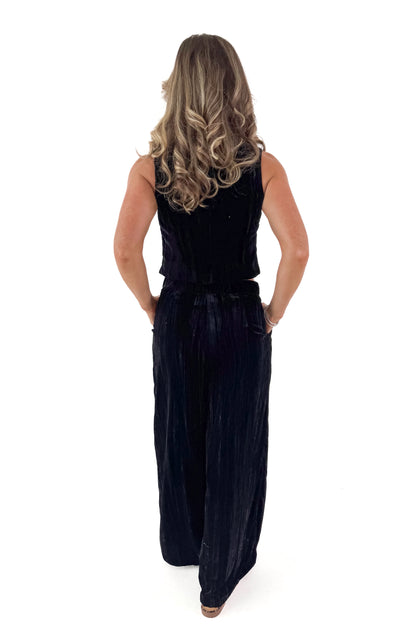 Back view of woman wearing Velvet V-neck Vest with matching pants against white studio background.