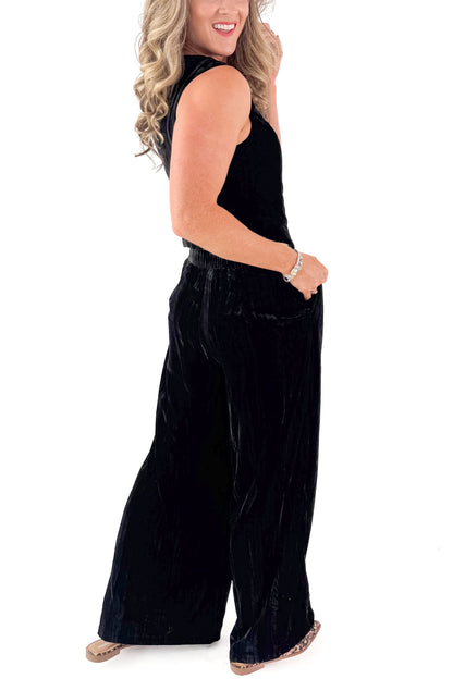 Side view of woman wearing Black Textured Velvet Wide Leg Pants and matching tank against white studio background.