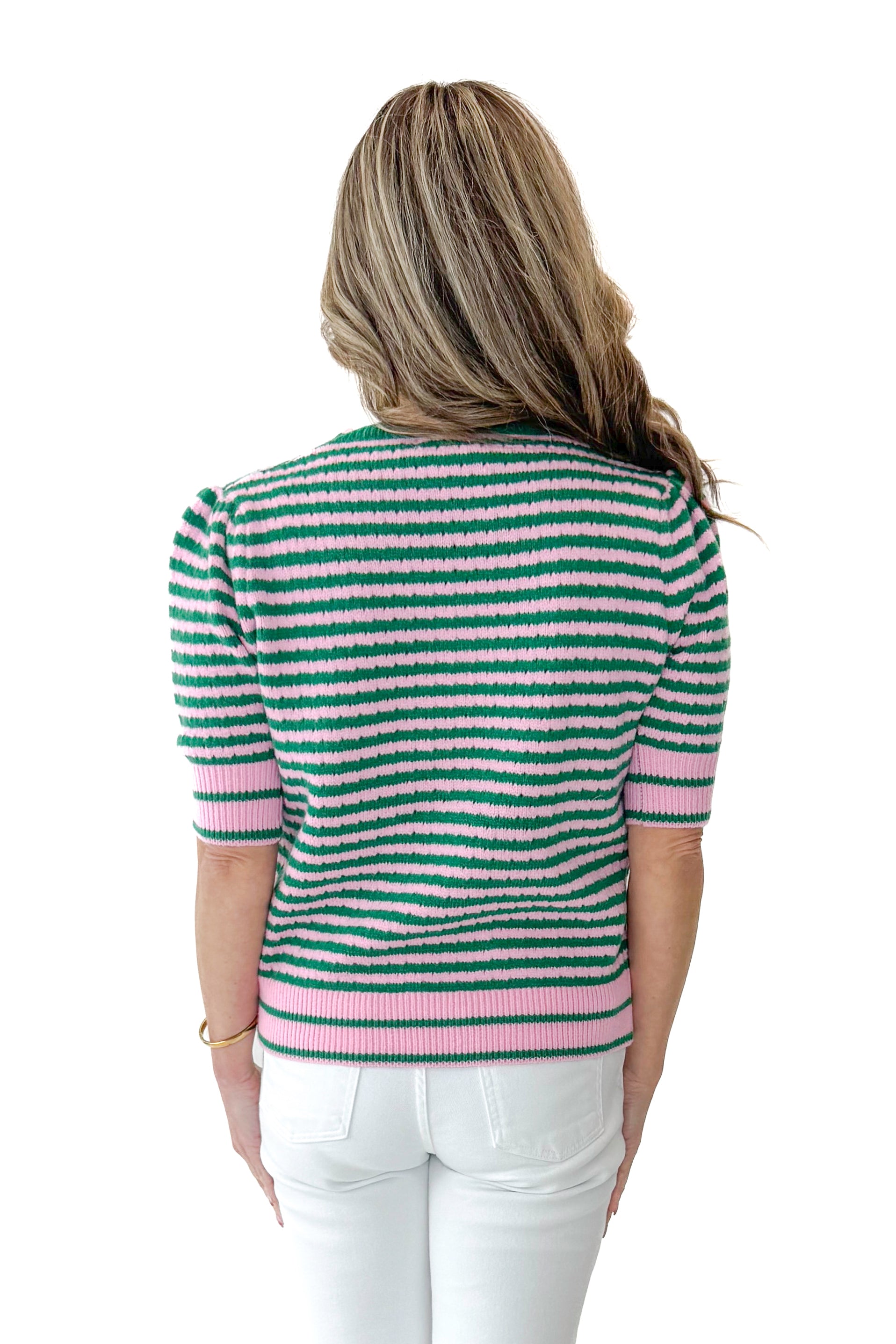 Back view of woman wearing Green &amp; Pink Striped Short Sleeve Sweater with jeans against white studio background.