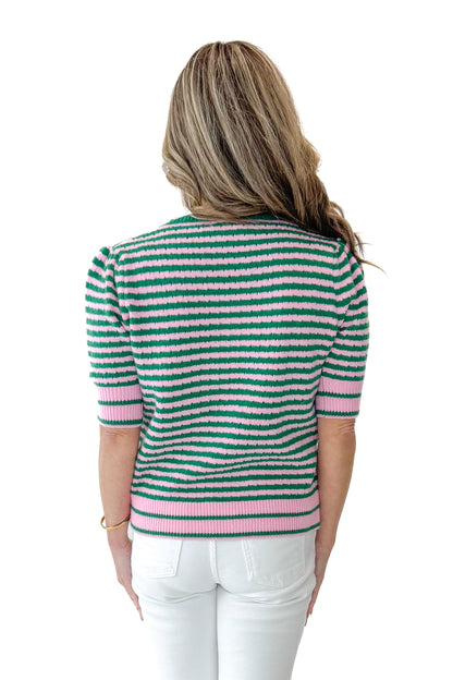 Back view of woman wearing Green &amp; Pink Striped Short Sleeve Sweater with jeans against white studio background.