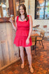 Front view of woman wearing Red Eyelet Hem Tie Detail Tank with matching skirt at a restaurant.