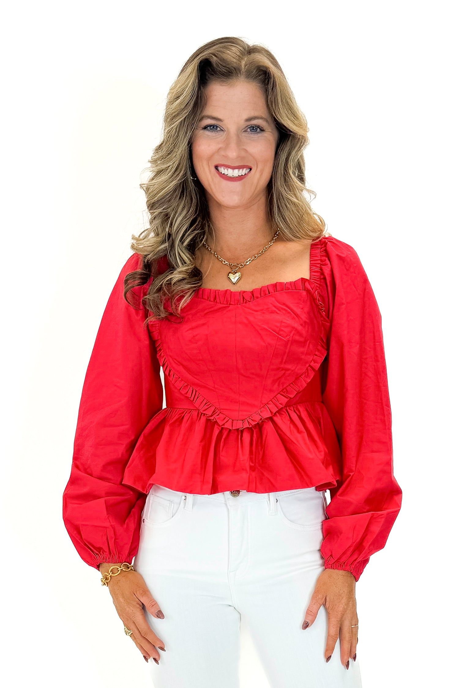 Front view of woman wearing Red Heart Detail Ruffle Top with jeans against white studio background.