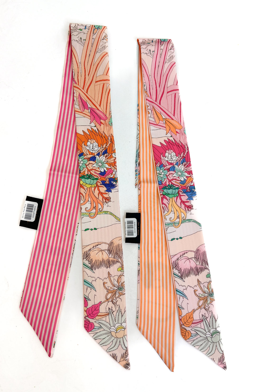 Two floral-patterned scarves with striped edges on a white background