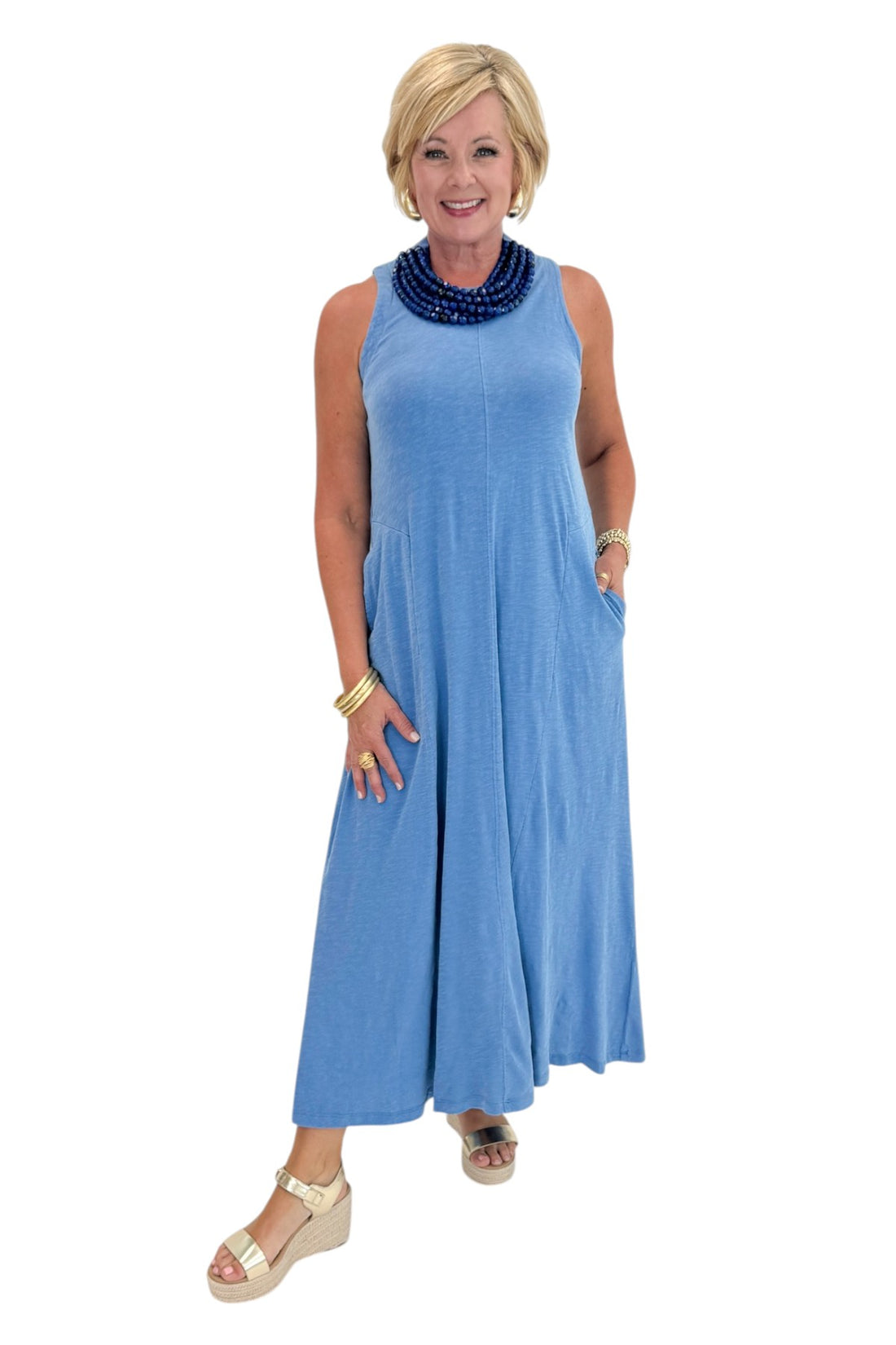 Front view of woman wearing Swagger Boutique’s Marina Waters Edge Midi Dress by Z Supply with sandals against white studio background.