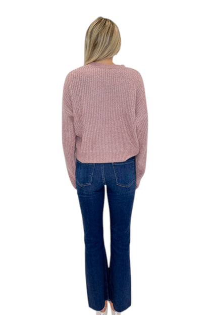Back view of woman wearing Swagger Boutique’s Mauve Ribbed sweater with jeans against white studio background.
