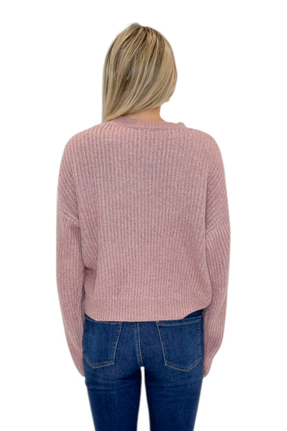 Back view of woman wearing Swagger Boutique’s Mauve Ribbed sweater with jeans against white studio background.