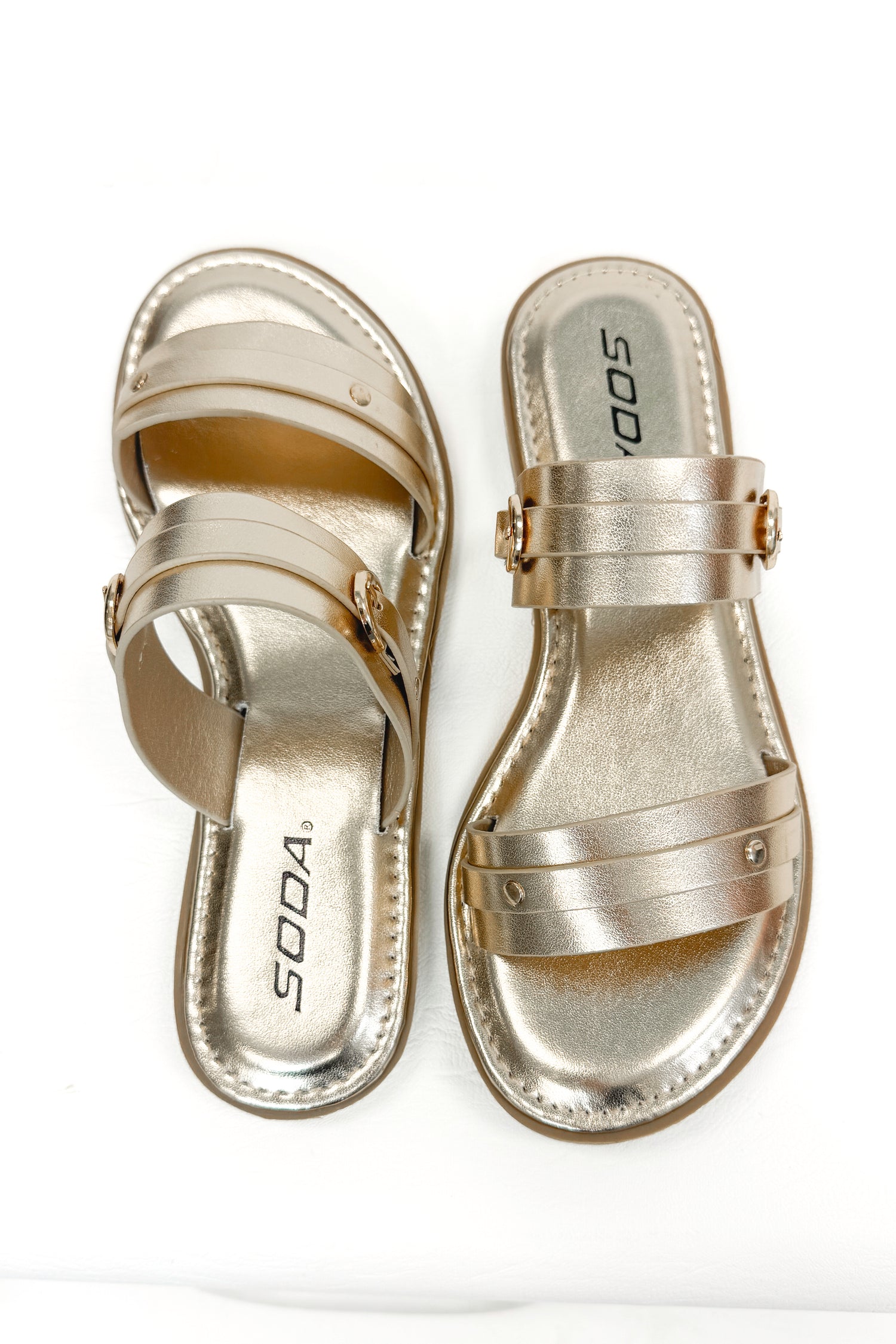 Maya- Gold Double Strap Buckle Detail Sandals against white studio background