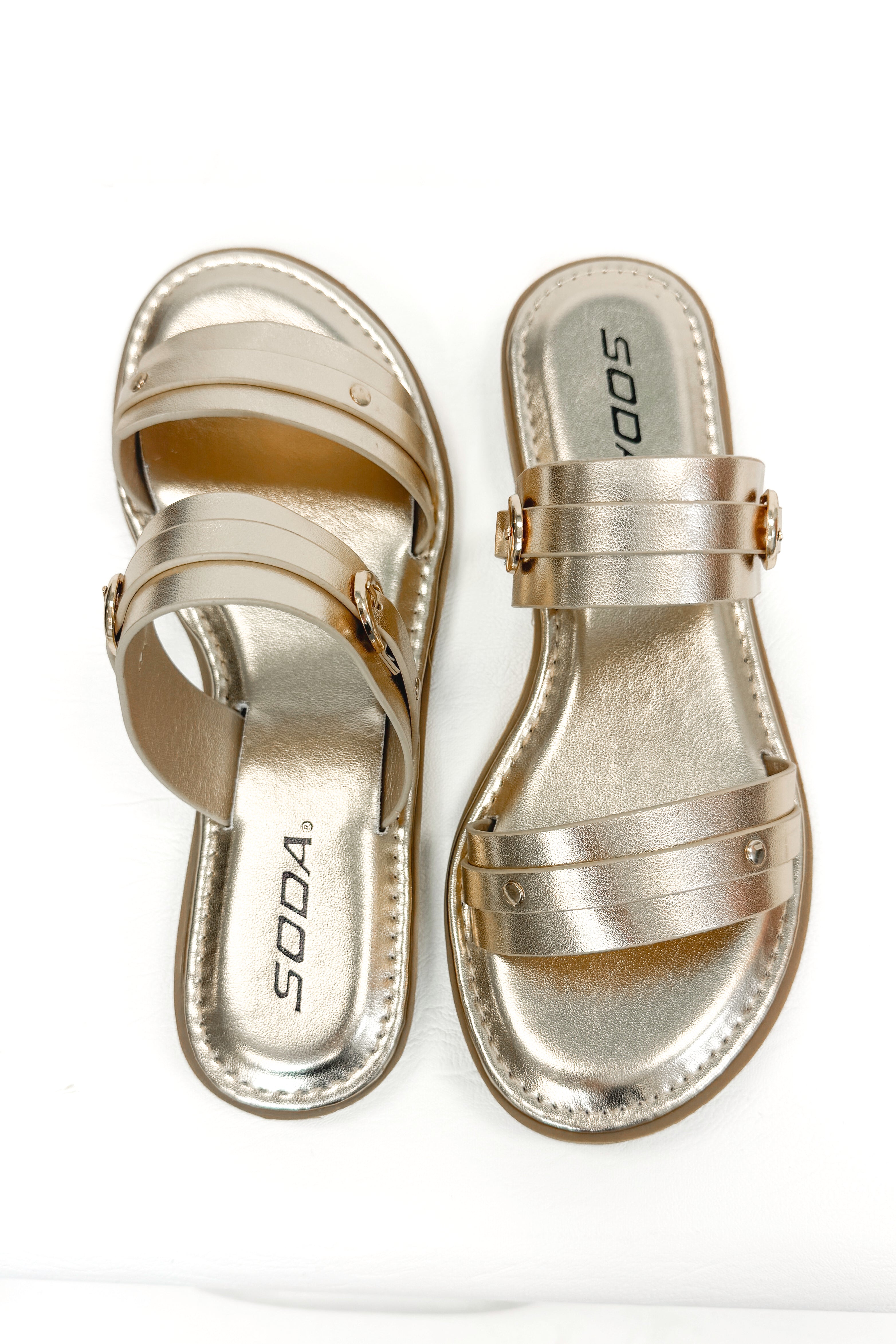 Maya- Gold Double Strap Buckle Detail Sandals against white studio background