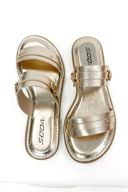 Maya- Gold Double Strap Buckle Detail Sandals against white studio background