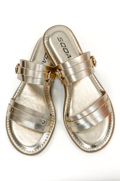 Maya- Gold Double Strap Buckle Detail Sandals against white studio background