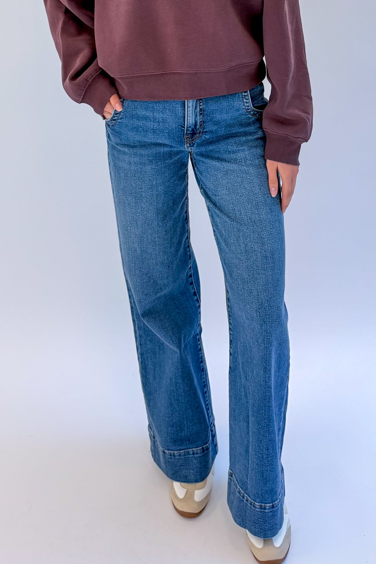 Front view of woman wearing Swagger Boutique’s Maya Wide Leg Jeans In Medium Wash- Journey by Kut from the Kloth against white studio background.