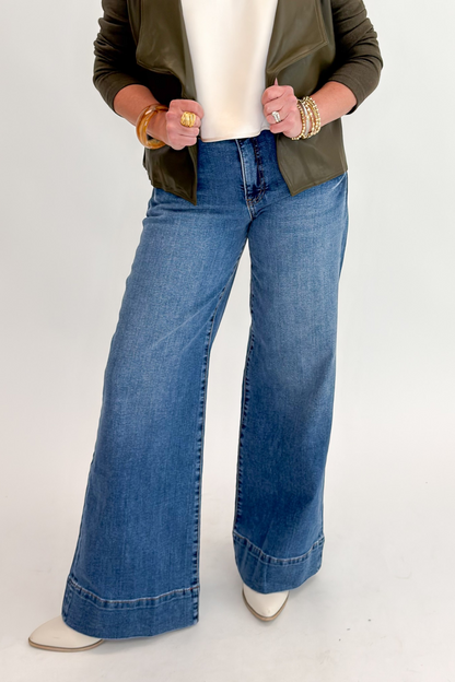 Front view of woman wearing Swagger Boutique’s Maya Wide Leg Jeans In Medium Wash- Journey by Kut from the Kloth against white studio background.