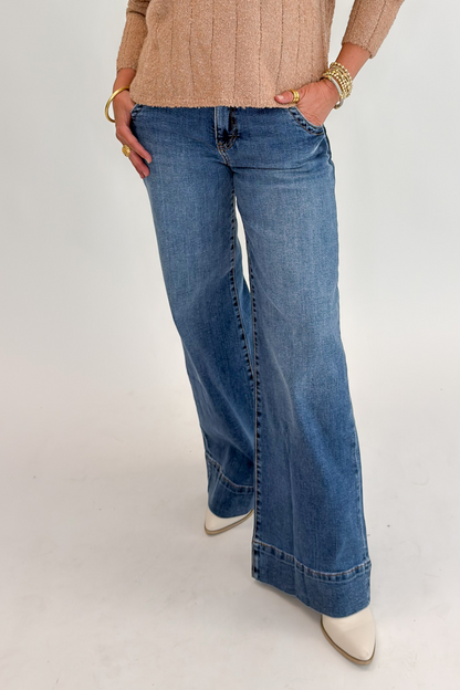 Front view of woman wearing Swagger Boutique’s Maya Wide Leg Jeans In Medium Wash- Journey by Kut from the Kloth against white studio background.