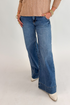Front view of woman wearing Swagger Boutique’s Maya Wide Leg Jeans In Medium Wash- Journey by Kut from the Kloth against white studio background.