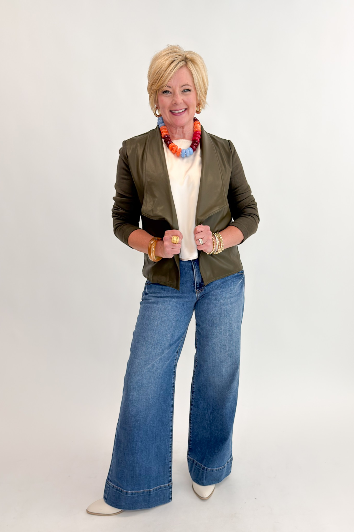 Front view of woman wearing Swagger Boutique’s Maya Wide Leg Jeans In Medium Wash- Journey by Kut from the Kloth against white studio background.