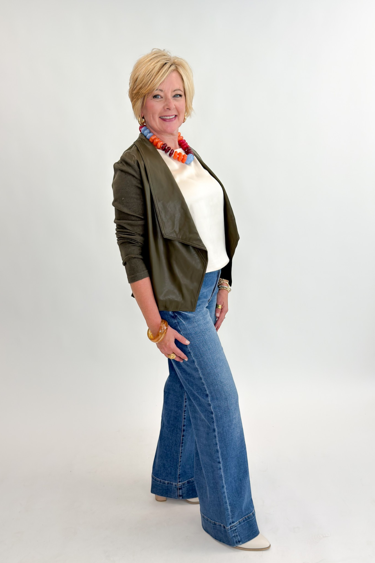 Side view of woman wearing Swagger Boutique’s Maya Wide Leg Jeans In Medium Wash- Journey by Kut from the Kloth against white studio background.