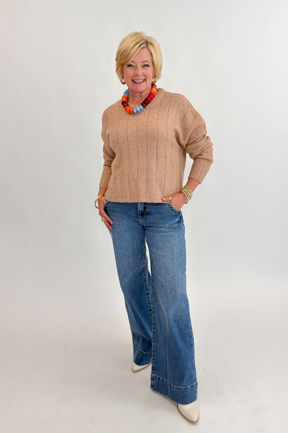 Front view of woman wearing Swagger Boutique’s Maya Wide Leg Jeans In Medium Wash- Journey by Kut from the Kloth against white studio background.