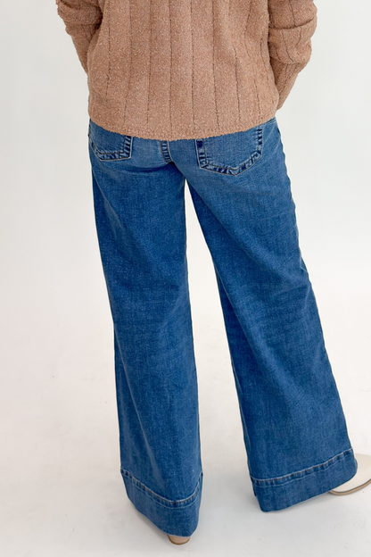 Back view of woman wearing Swagger Boutique’s Maya Wide Leg Jeans In Medium Wash- Journey by Kut from the Kloth against white studio background.