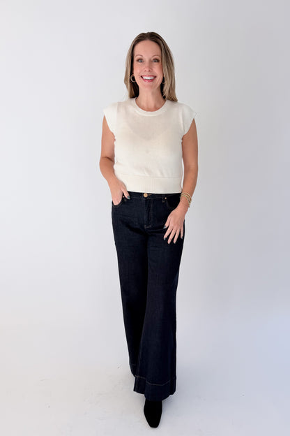 Front view of woman wearing Swagger Boutique’s sweater with Maya Wide Leg Jeans In Dark Wash- Amaze by Kut from the Kloth against white studio background.