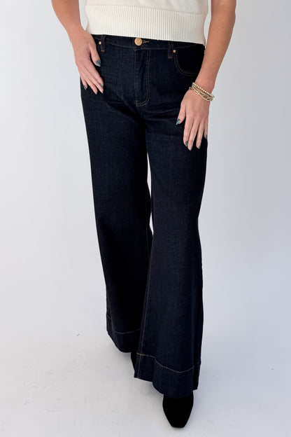 Front view of woman wearing Swagger Boutique’s sweater with Maya Wide Leg Jeans In Dark Wash- Amaze by Kut from the Kloth against white studio background.