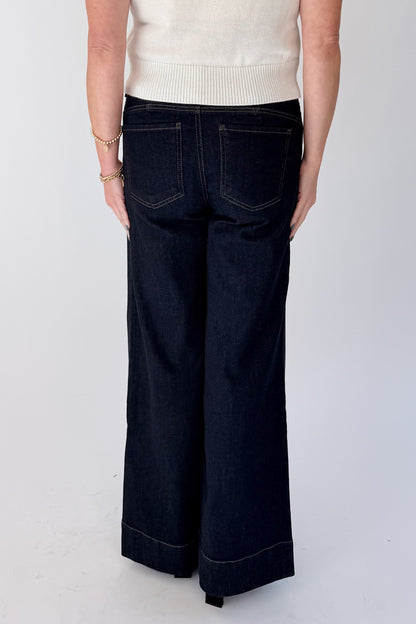 Back view of woman wearing Swagger Boutique’s sweater with Maya Wide Leg Jeans In Dark Wash- Amaze by Kut from the Kloth against white studio background.