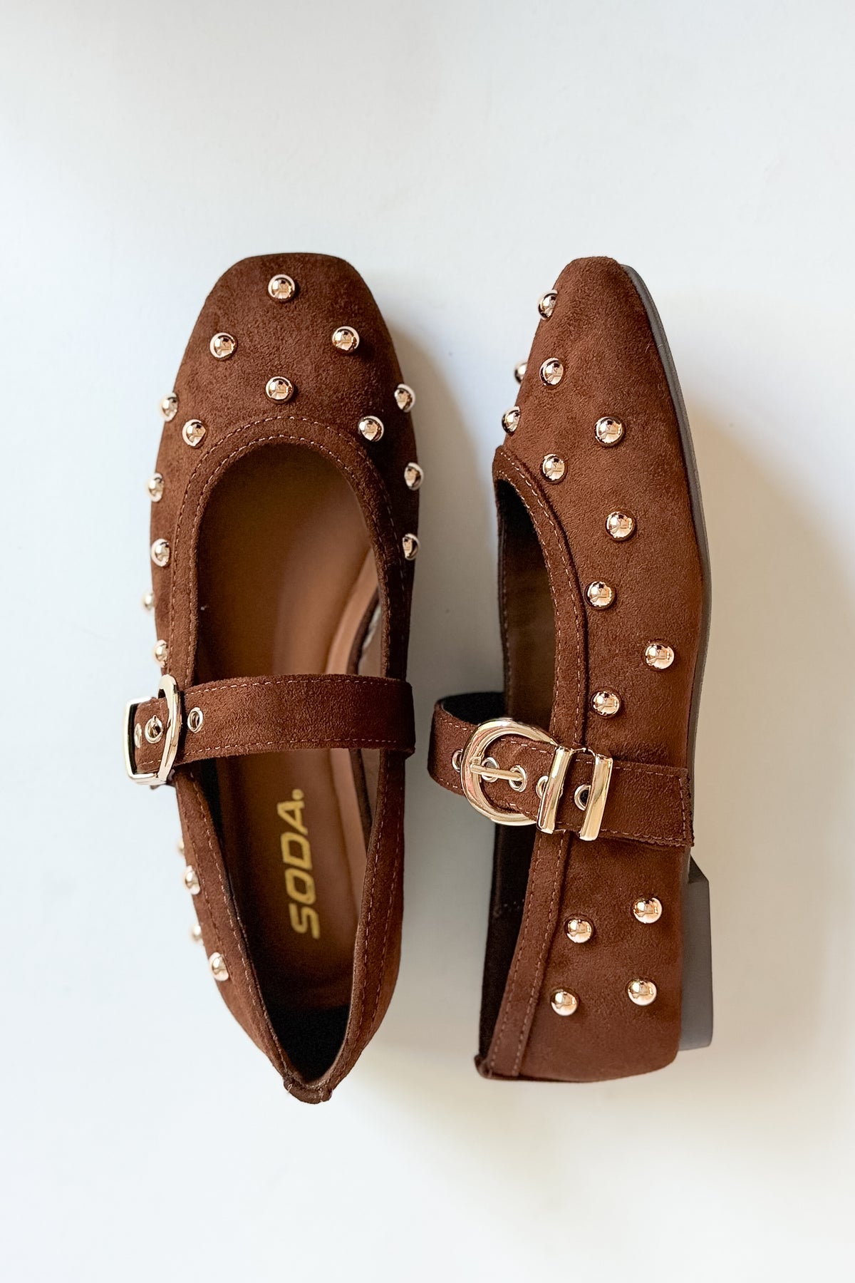 Mayhap- Brown Studded Flats against white background.