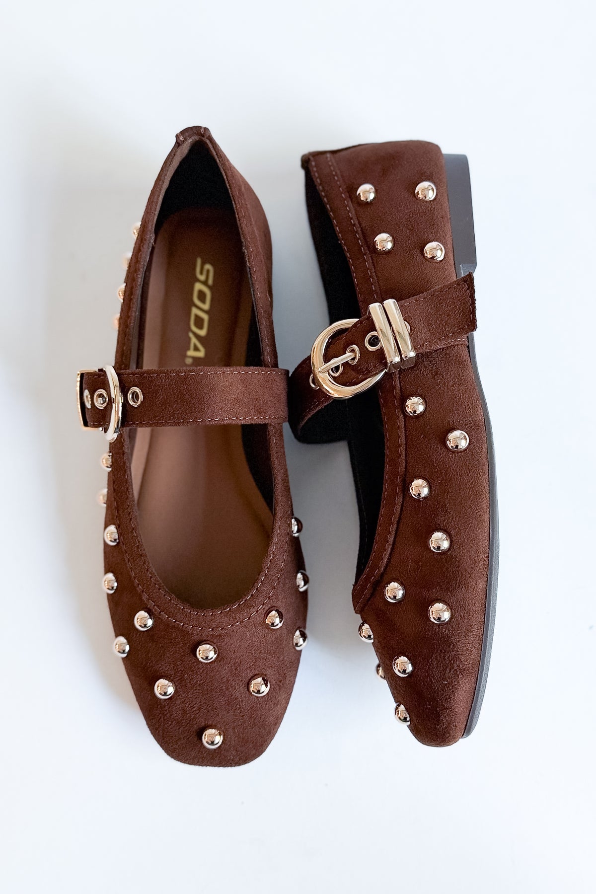 Mayhap- Brown Studded Flats against white background.