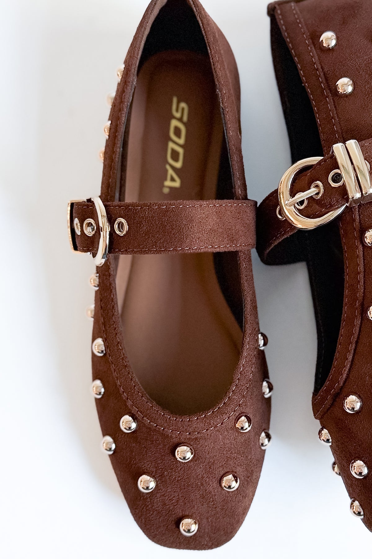 Mayhap- Brown Studded Flats against white background.