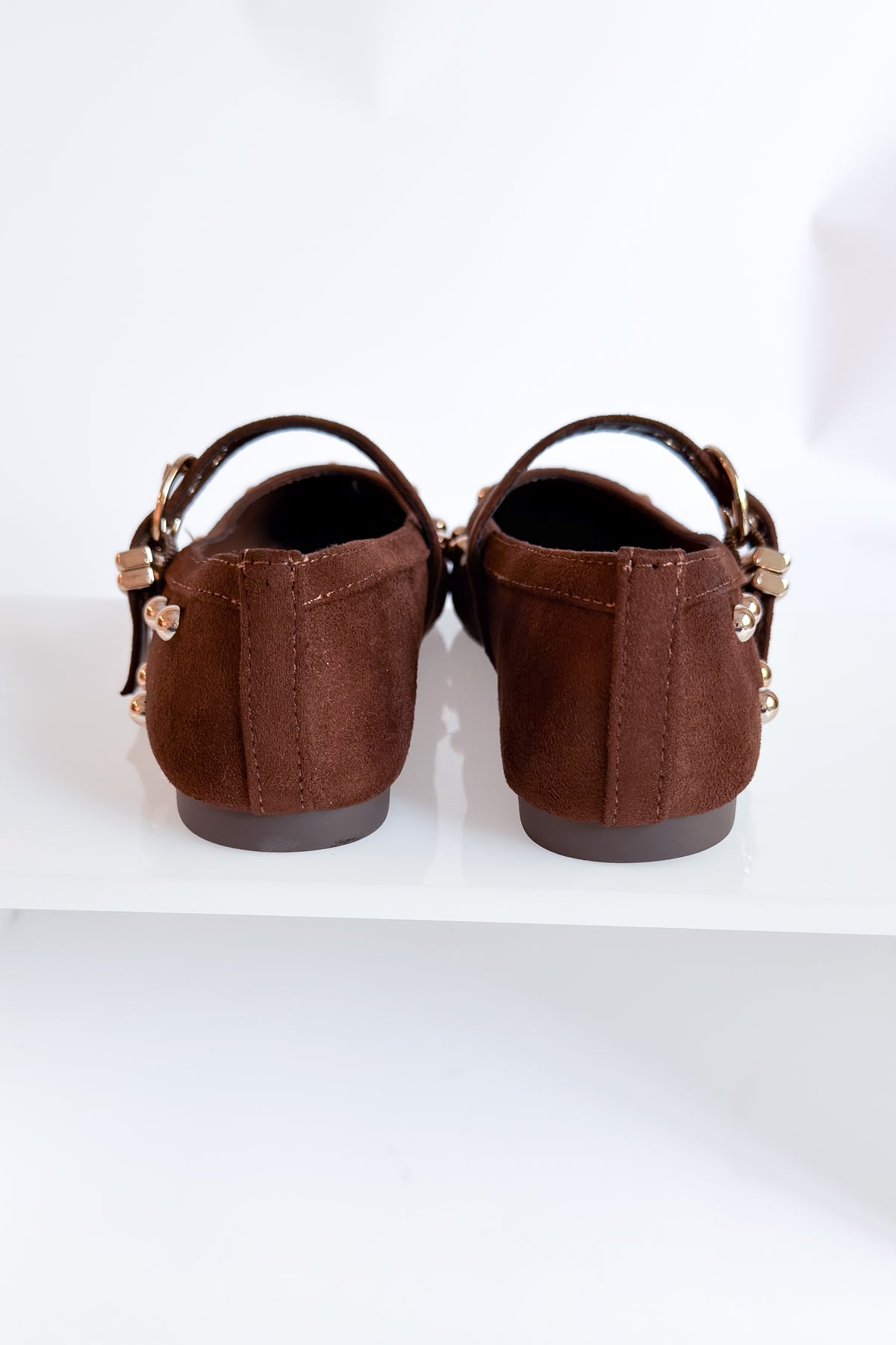 Mayhap- Brown Studded Flats against white background.