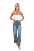 Front view of woman wearing Swagger Boutique’s Medium Wash Brown Stripe Detail Jeans against white studio background.