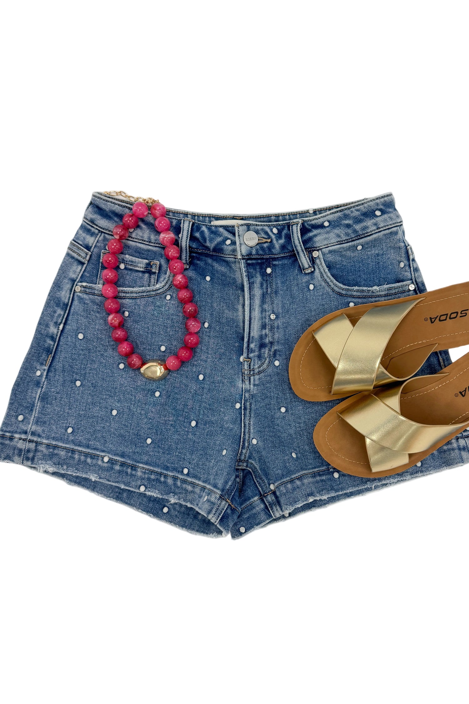 Swagger Boutique’s Medium Wash Polka Dot Denim Shorts against white studio background.