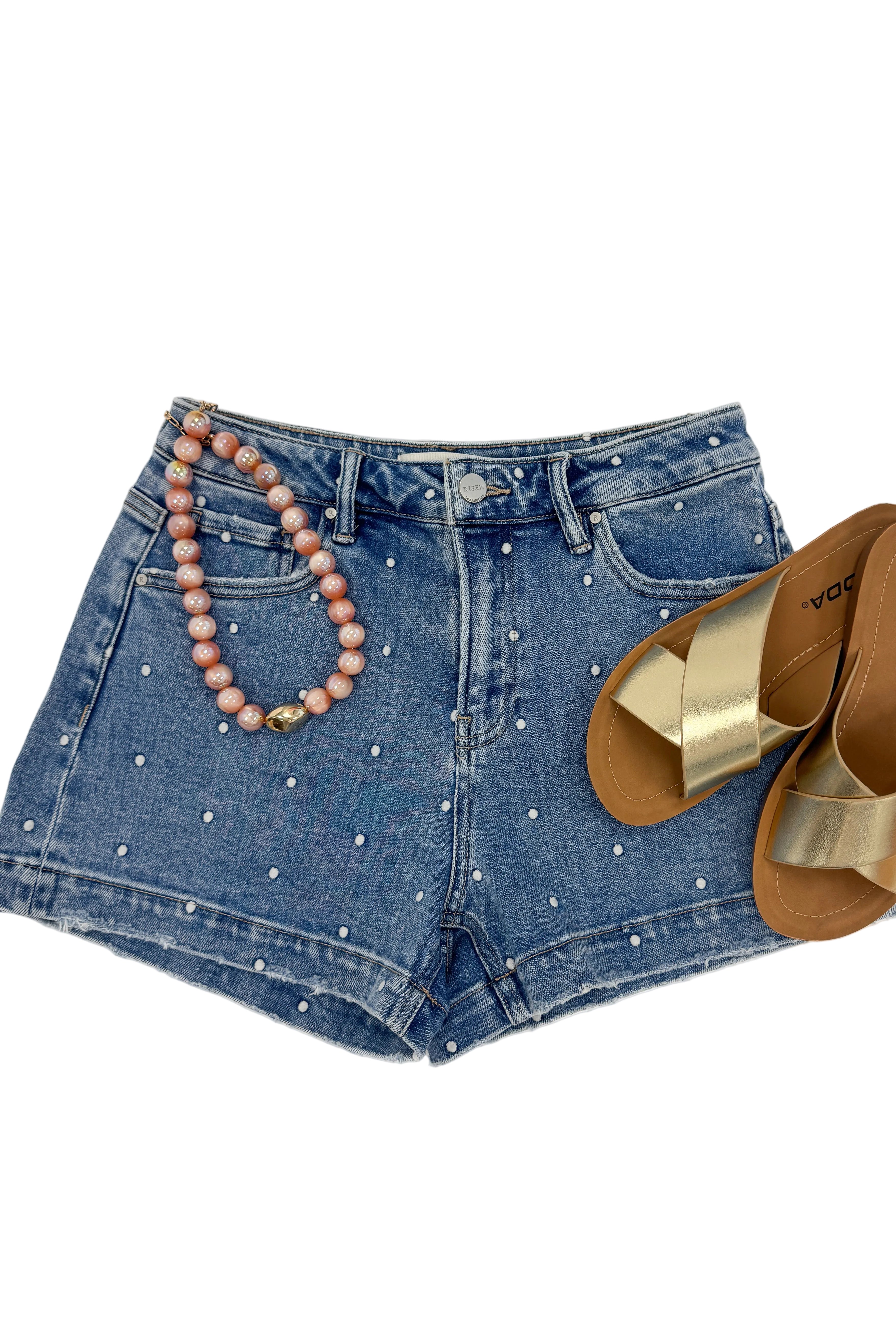 Swagger Boutique’s Medium Wash Polka Dot Denim Shorts against white studio background.