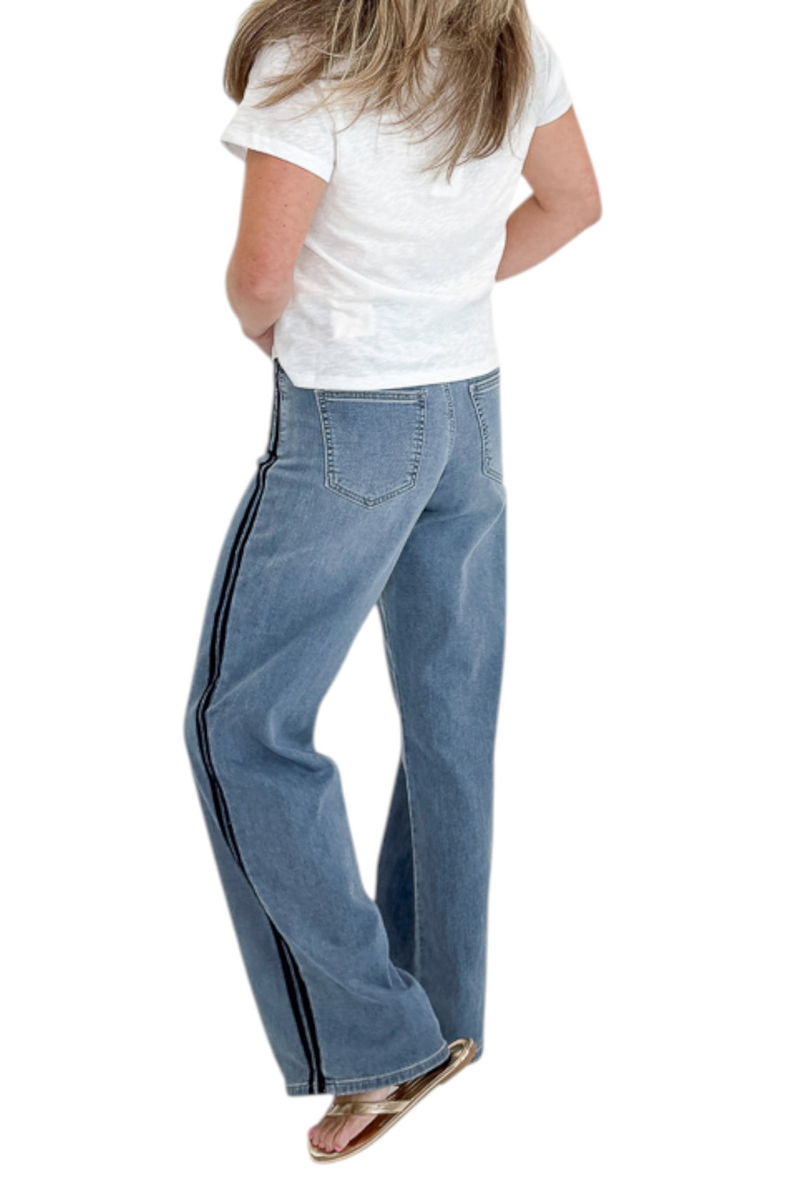 Back view of woman wearing Swagger Boutique’s Medium Wash Tuxedo Stripe Jeans by Just Black Denim with white top against white studio background.