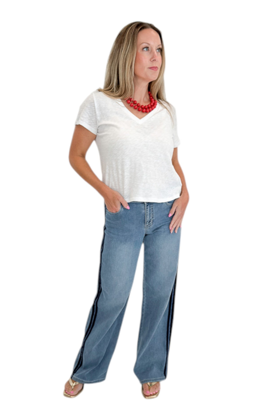 Front view of woman wearing Swagger Boutique’s Medium Wash Tuxedo Stripe Jeans by Just Black Denim with white top against white studio background.