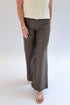 Front view of woman wearing Swagger Boutique’s sweater with Meg Coated Wide Leg Jeans in Toffee by Kut from the Kloth against white studio background.