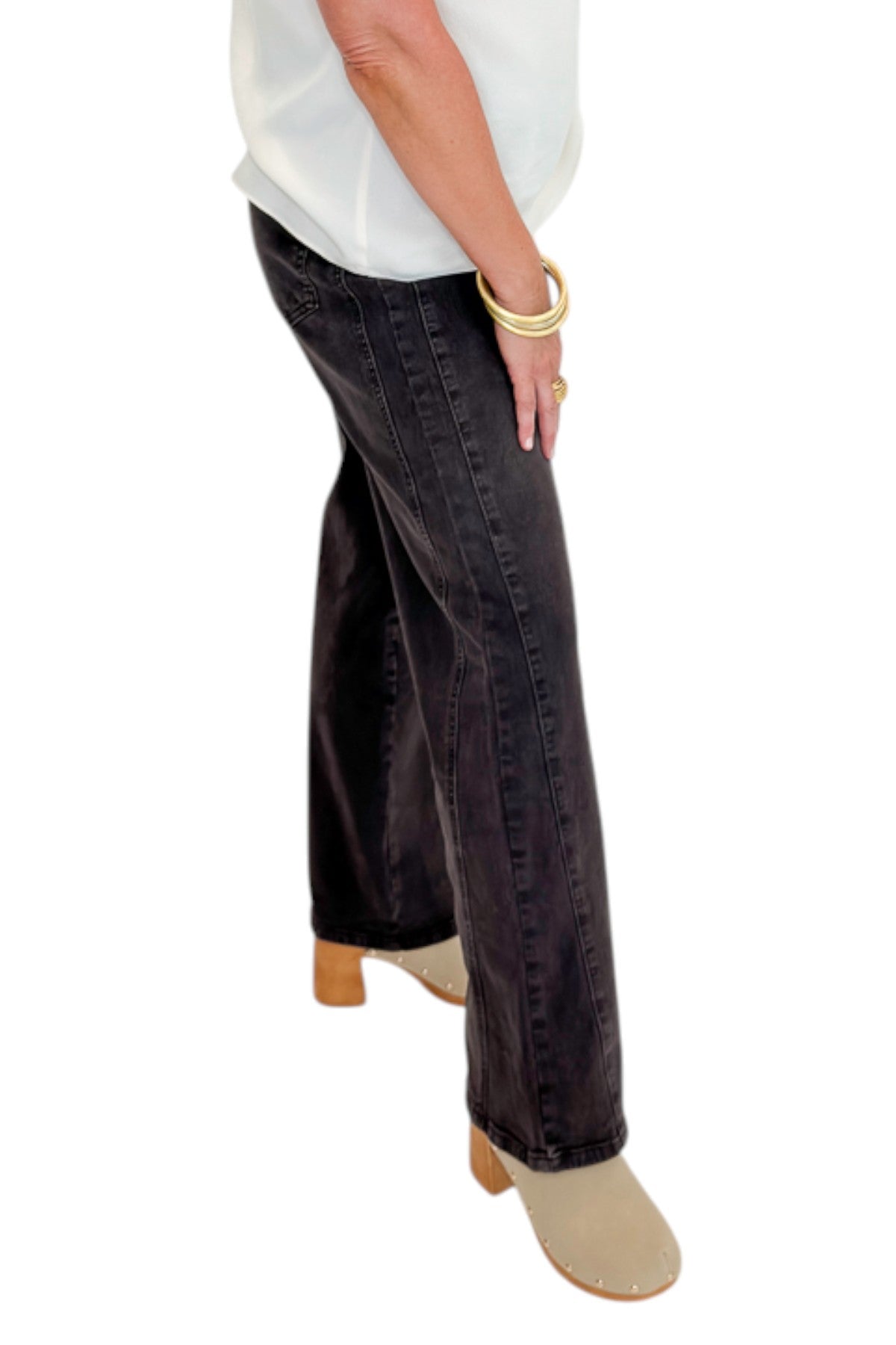 Side view of woman wearing Swagger Boutique’s Meg Wide Leg Jeans in Chocolate by Kut from the Kloth with top against white studio background.