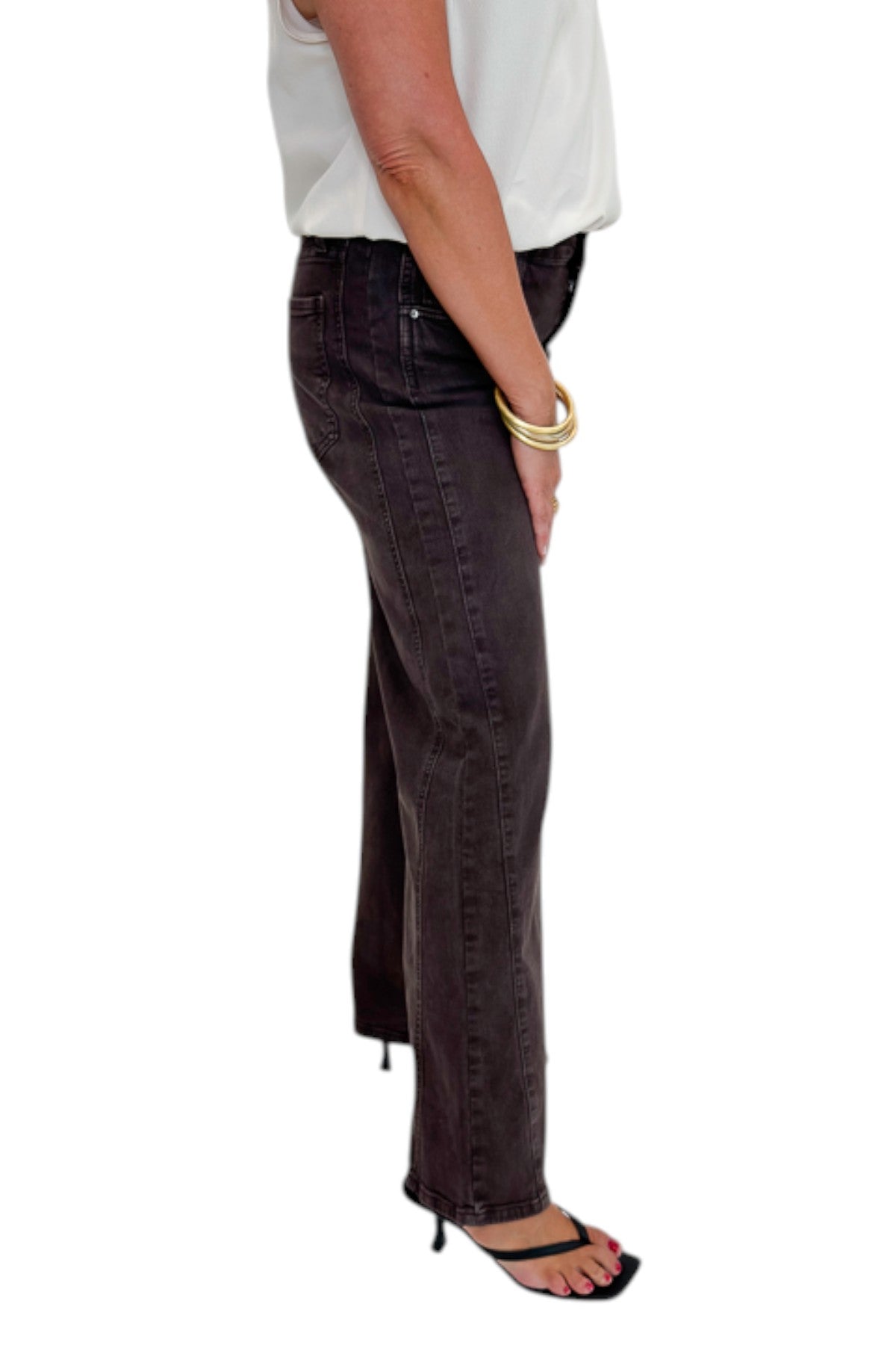 Side view of woman wearing Swagger Boutique’s Meg Wide Leg Jeans in Chocolate by Kut from the Kloth with top against white studio background.