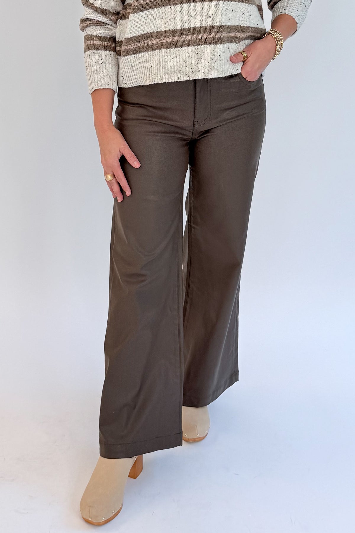 Front view of woman wearing Swagger Boutique’s sweater with Meg Coated Wide Leg Jeans in Toffee by Kut from the Kloth against white studio background.