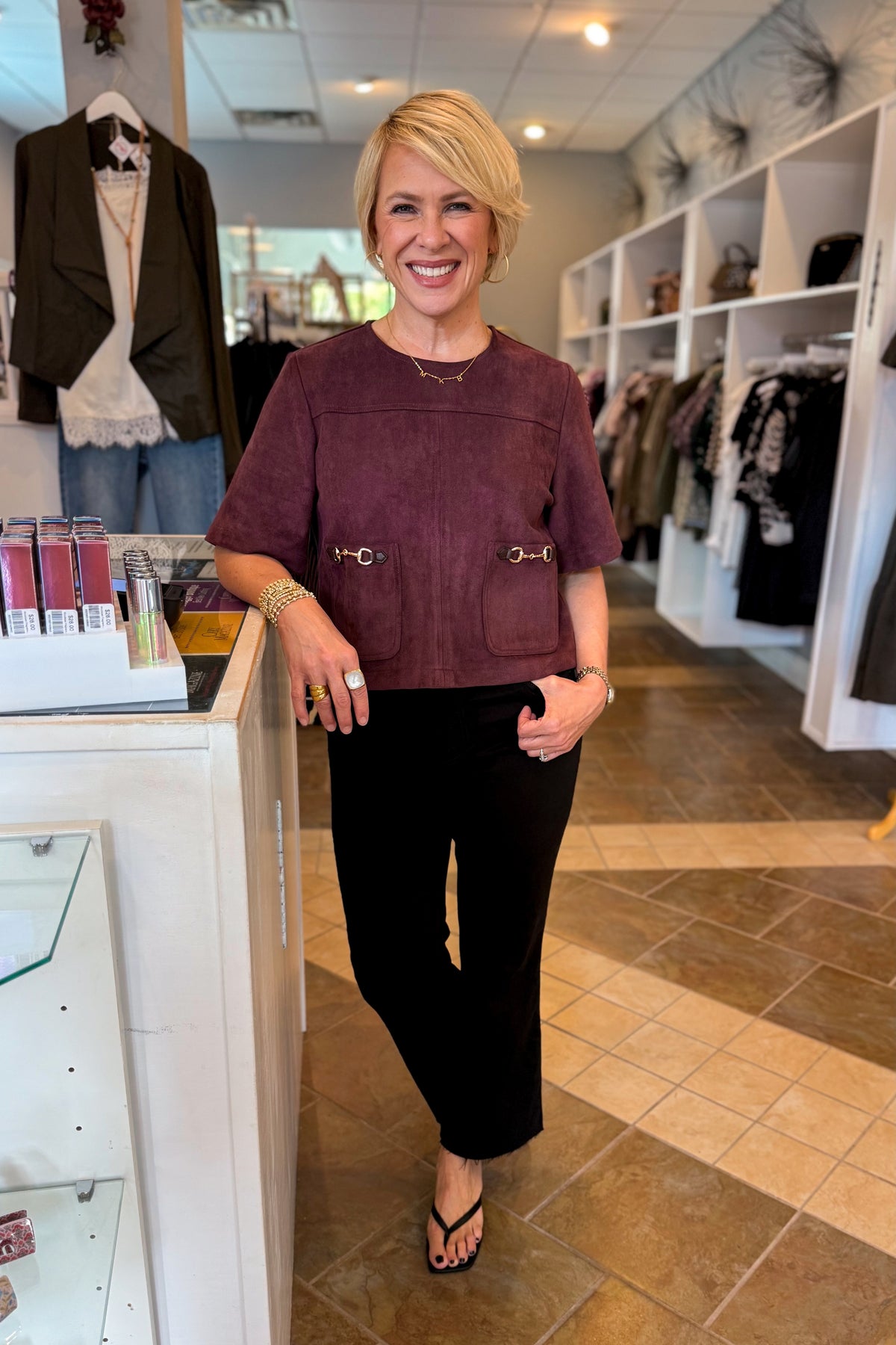 Front view of woman standing at Swagger Boutique wearing Merlot Suede Horsebit Pocket Top by Entro with jeans. 