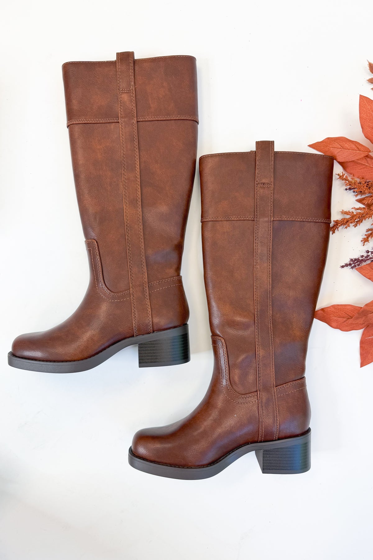 Mizell- Brown Tall Boots against white studio background side view.