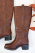 Mizell- Brown Tall Boots against white studio background side view.