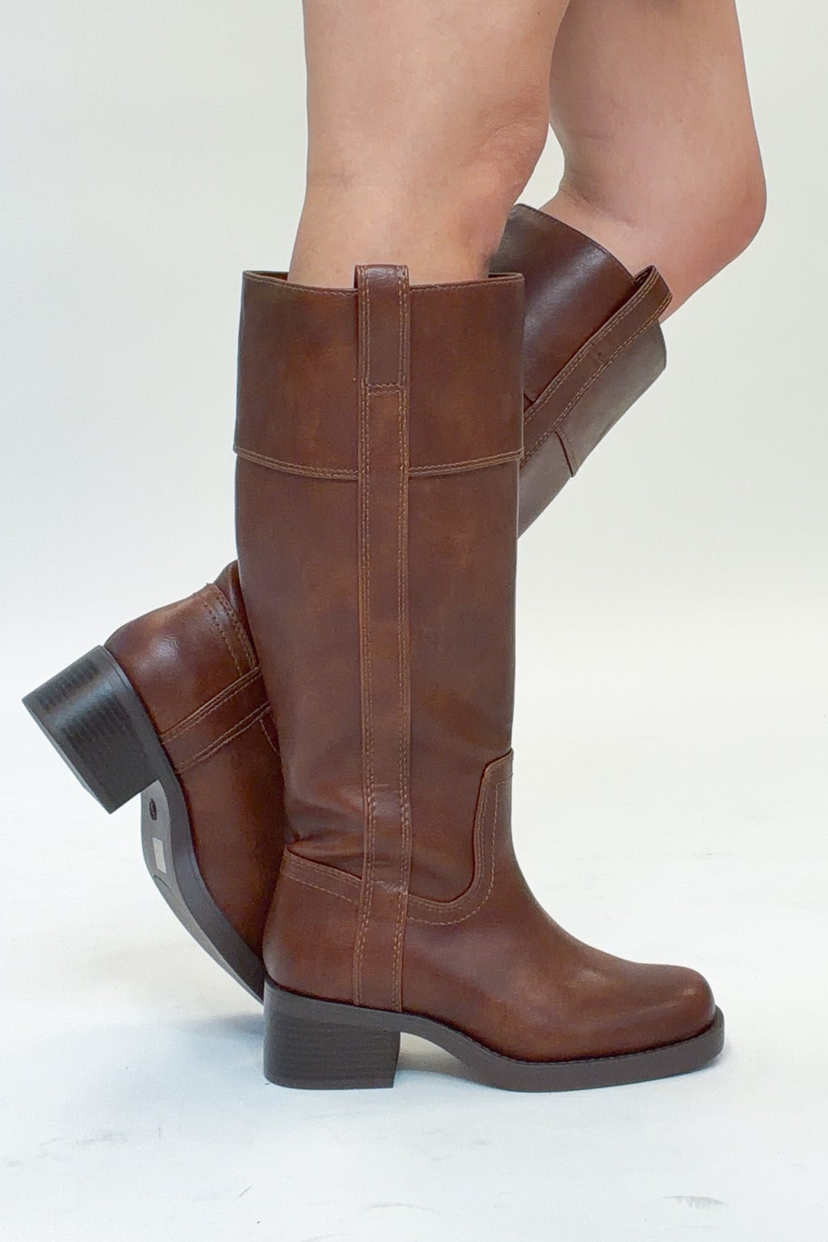 Mizell- Brown Tall Boots against white studio background side view.
