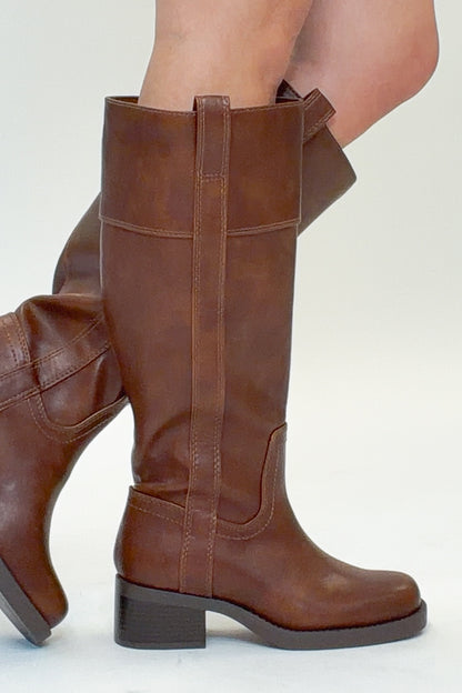 Mizell- Brown Tall Boots against white studio background side view.