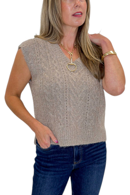 Front detail view of woman wearing Swagger Boutique’s Mocha Cable Knit V-neck Sweat Vest with jeans against white studio background.