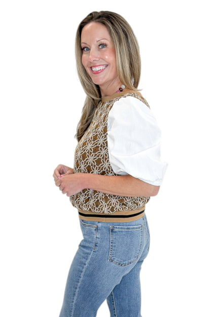 Side view of woman wearing Swagger Boutique’s Mocha Floral Crocheted Contrast Sleeve Top with jeans against white studio background.