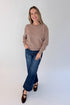 Front view of woman wearing Swagger Boutique’s Mocha Ribbed Hem Sweatshirt with jeans against white studio background.