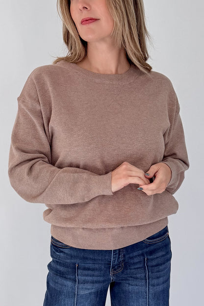 Front detail view of woman wearing Swagger Boutique’s Mocha Ribbed Hem Sweatshirt with jeans against white studio background.